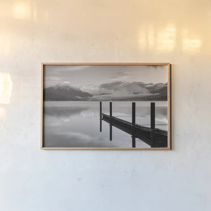 Lake McDonald Dock BW by Alan Majchrowicz. shown as a paper print in a natural frame. Available as a archival giclee rolled canvas, fine art paper, or poster print. SKU 50227i.