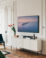 Lake Superior Old Pier IV by Alan Majchrowicz. shown as a framed stretched canvas in a living room above a console. Available as a archival giclee rolled canvas, fine art paper, or poster print. SKU 50406i.