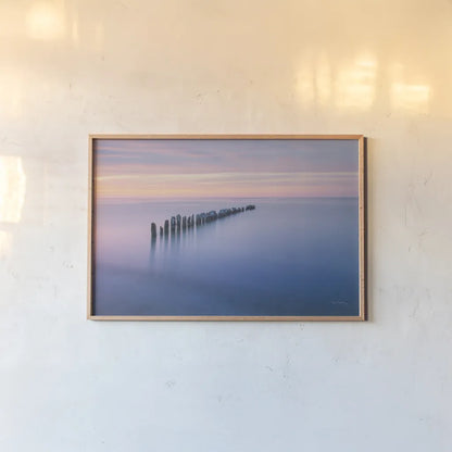 Lake Superior Old Pier IV by Alan Majchrowicz. shown as a paper print in a natural frame. Available as a archival giclee rolled canvas, fine art paper, or poster print. SKU 50406i.