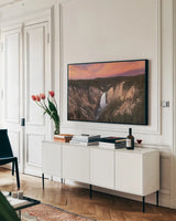 Lower Falls of the Yellowstone River I by Alan Majchrowicz. shown as a framed stretched canvas in a living room above a console. Available as a archival giclee rolled canvas, fine art paper, or poster print. SKU 80841i.