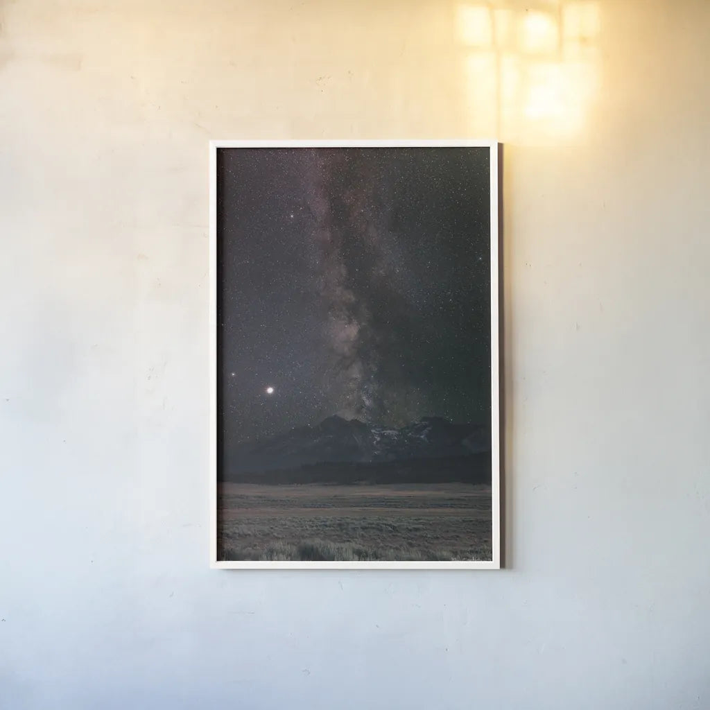 Milky Way in Sawtooth Mountains by Alan Majchrowicz. shown as a paper print in a white frame. Available as a archival giclee rolled canvas, fine art paper, or poster print. SKU 68097h.