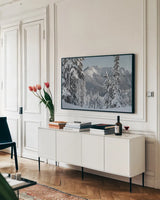 Nooksack Ridge in Winter by Alan Majchrowicz. shown as a framed stretched canvas in a living room above a console. Available as a archival giclee rolled canvas, fine art paper, or poster print. SKU 60625i.