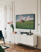 Palouse Region Red Barn I by Alan Majchrowicz. shown as a framed stretched canvas in a living room above a console. Available as a archival giclee rolled canvas, fine art paper, or poster print. SKU 67697i.