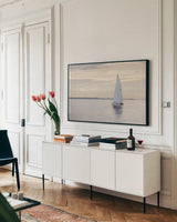 Sailboat in Semiahmoo Bay by Alan Majchrowicz. shown as a framed stretched canvas in a living room above a console. Available as a archival giclee rolled canvas, fine art paper, or poster print. SKU 46112i.