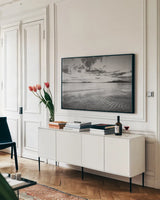 Samish Bay Sunset II BW by Alan Majchrowicz. shown as a framed stretched canvas in a living room above a console. Available as a archival giclee rolled canvas, fine art paper, or poster print. SKU 33852i.