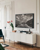 Sawtooth Lake Reflection I by Alan Majchrowicz. shown as a framed stretched canvas in a living room above a console. Available as a archival giclee rolled canvas, fine art paper, or poster print. SKU 64553i.