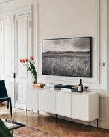 Sawtooth Mountains Idaho II BW by Alan Majchrowicz. shown as a framed stretched canvas in a living room above a console. Available as a archival giclee rolled canvas, fine art paper, or poster print. SKU 73660i.
