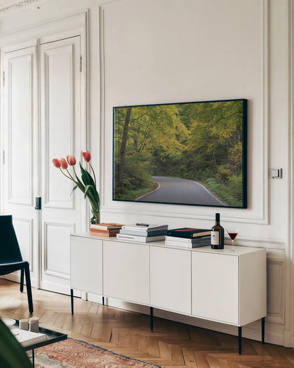 Smugglers Notch Road by Alan Majchrowicz. shown as a framed stretched canvas in a living room above a console. Available as a archival giclee rolled canvas, fine art paper, or poster print. SKU 62467i.
