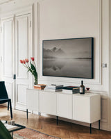 Stanley Lake Idaho BW by Alan Majchrowicz. shown as a framed stretched canvas in a living room above a console. Available as a archival giclee rolled canvas, fine art paper, or poster print. SKU 81457i.