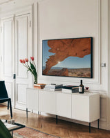 Sunset Arch Grand Staircase Escalante National Monument by Alan Majchrowicz. shown as a framed stretched canvas in a living room above a console. Available as a archival giclee rolled canvas, fine art paper, or poster print. SKU 80813i.