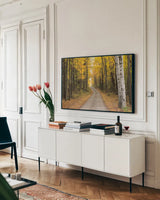 Vermont Country Road by Alan Majchrowicz. shown as a framed stretched canvas in a living room above a console. Available as a archival giclee rolled canvas, fine art paper, or poster print. SKU 12988i.