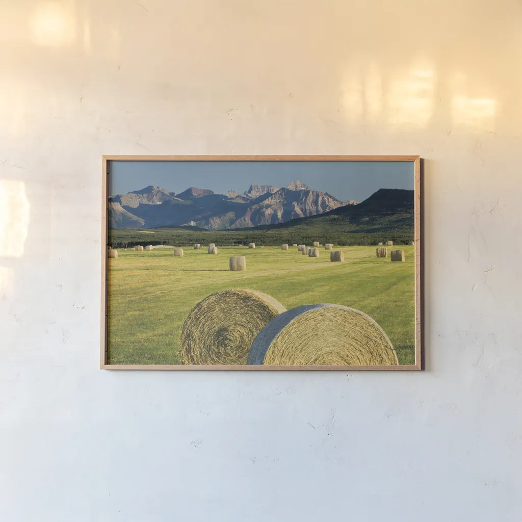 Waterton Hay Bales by Alan Majchrowicz. shown as a paper print in a natural frame. Available as a archival giclee rolled canvas, fine art paper, or poster print. SKU 53741i.