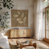 Autumn Leaves White on Taupe I by Albena Hristova. Shown in a natural wood frame in a cozy modern living room. Available as an archival giclee rolled canvas, fine art paper, or poster print. SKU 55458a.