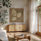 Autumn Leaves White on Taupe III by Albena Hristova. Shown in a natural wood frame in a cozy modern living room. Available as an archival giclee rolled canvas, fine art paper, or poster print. SKU 55460a.