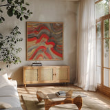 Floating Lava Red by Albena Hristova. Shown in a natural wood frame in a cozy modern living room. Available as an archival giclee rolled canvas, fine art paper, or poster print. SKU 55940a.