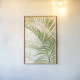 Palms I Bright by Albena Hristova. shown as a paper print in a natural frame. Available as a archival giclee rolled canvas, fine art paper, or poster print. SKU 48327h.