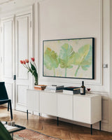 Tropical Trio by Albena Hristova. shown as a framed stretched canvas in a living room above a console. Available as a archival giclee rolled canvas, fine art paper, or poster print. SKU 54067i.