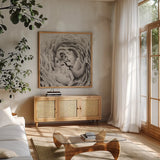 BW Peony by Aledanda. Shown in a natural wood frame in a cozy modern living room. Available as an archival giclee rolled canvas, fine art paper, or poster print. SKU 43251a.