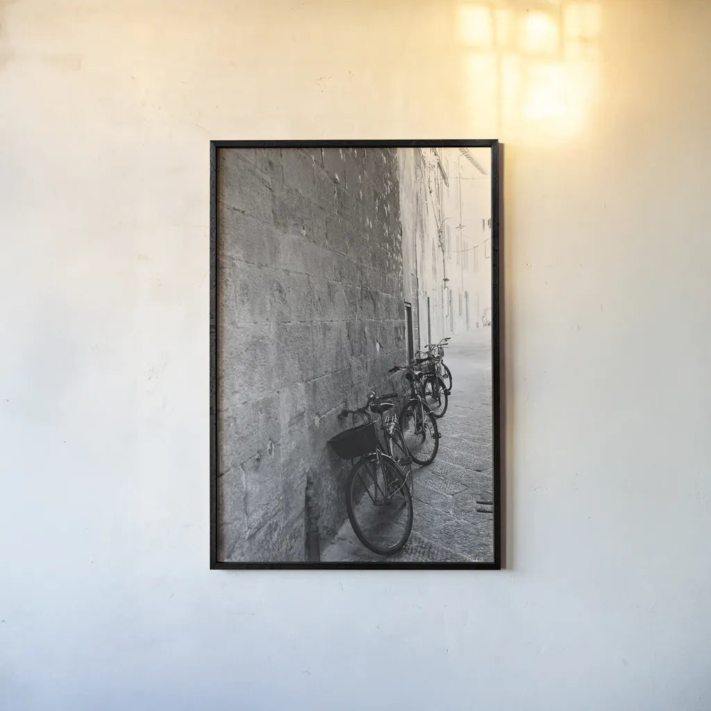 Bicycles in the Alley by Aledanda. shown as a paper print in a black flame. Available as a archival giclee rolled canvas, fine art paper, or poster print. SKU 67688h.
