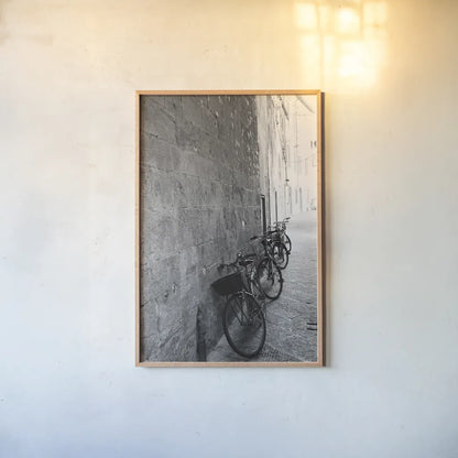 Bicycles in the Alley by Aledanda. shown as a paper print in a natural frame. Available as a archival giclee rolled canvas, fine art paper, or poster print. SKU 67688h.