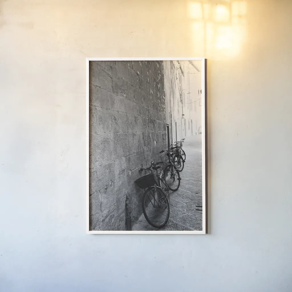 Bicycles in the Alley by Aledanda. shown as a paper print in a white frame. Available as a archival giclee rolled canvas, fine art paper, or poster print. SKU 67688h.