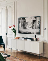 Cafe Cat by Aledanda. shown as a framed stretched canvas in a living room above a console. Available as a archival giclee rolled canvas, fine art paper, or poster print. SKU 101053i.