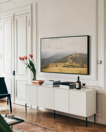 Grassy Hills and Mountains by Aledanda. shown as a framed stretched canvas in a living room above a console. Available as a archival giclee rolled canvas, fine art paper, or poster print. SKU 63229i.