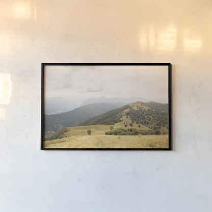 Grassy Hills and Mountains by Aledanda. shown as a paper print in a black flame. Available as a archival giclee rolled canvas, fine art paper, or poster print. SKU 63229i.