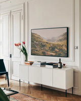 In the Valley by Aledanda. shown as a framed stretched canvas in a living room above a console. Available as a archival giclee rolled canvas, fine art paper, or poster print. SKU 38320i.