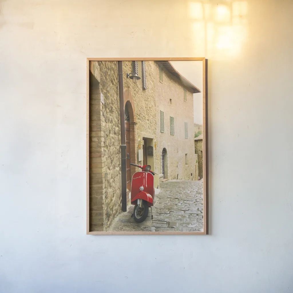 Italian Scooter by Aledanda. shown as a paper print in a natural frame. Available as a archival giclee rolled canvas, fine art paper, or poster print. SKU 72738h.