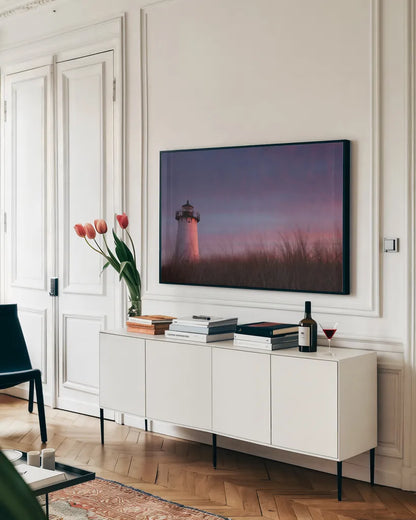 Lighthouse at Sunset Crop by Aledanda. shown as a framed stretched canvas in a living room above a console. Available as a archival giclee rolled canvas, fine art paper, or poster print. SKU 46207i.