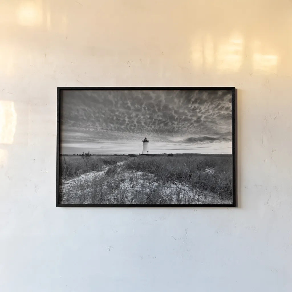 Lighthouse on Coast by Aledanda. shown as a paper print in a black flame. Available as a archival giclee rolled canvas, fine art paper, or poster print. SKU 37448i.