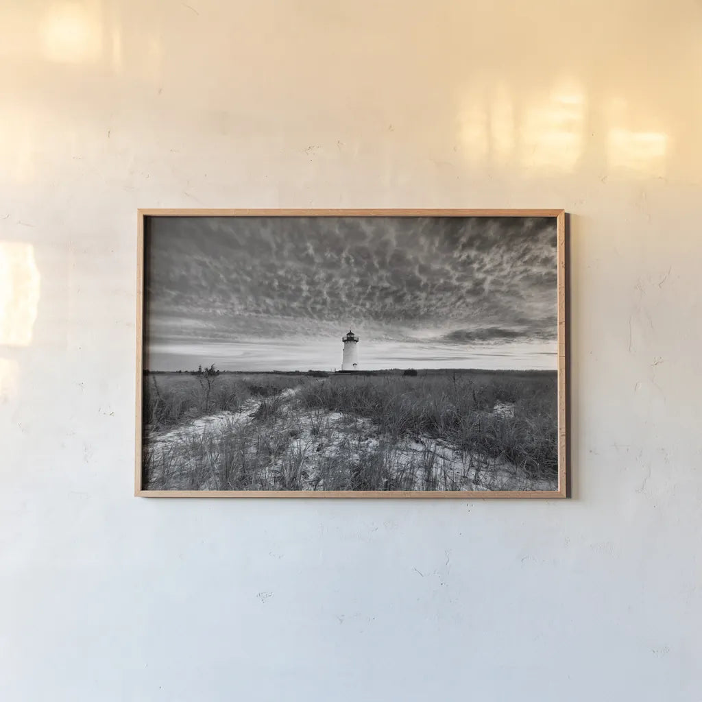 Lighthouse on Coast by Aledanda. shown as a paper print in a natural frame. Available as a archival giclee rolled canvas, fine art paper, or poster print. SKU 37448i.