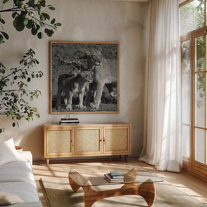 Lioness and Cubs by Aledanda. Shown in a natural wood frame in a cozy modern living room. Available as an archival giclee rolled canvas, fine art paper, or poster print. SKU 58138a.