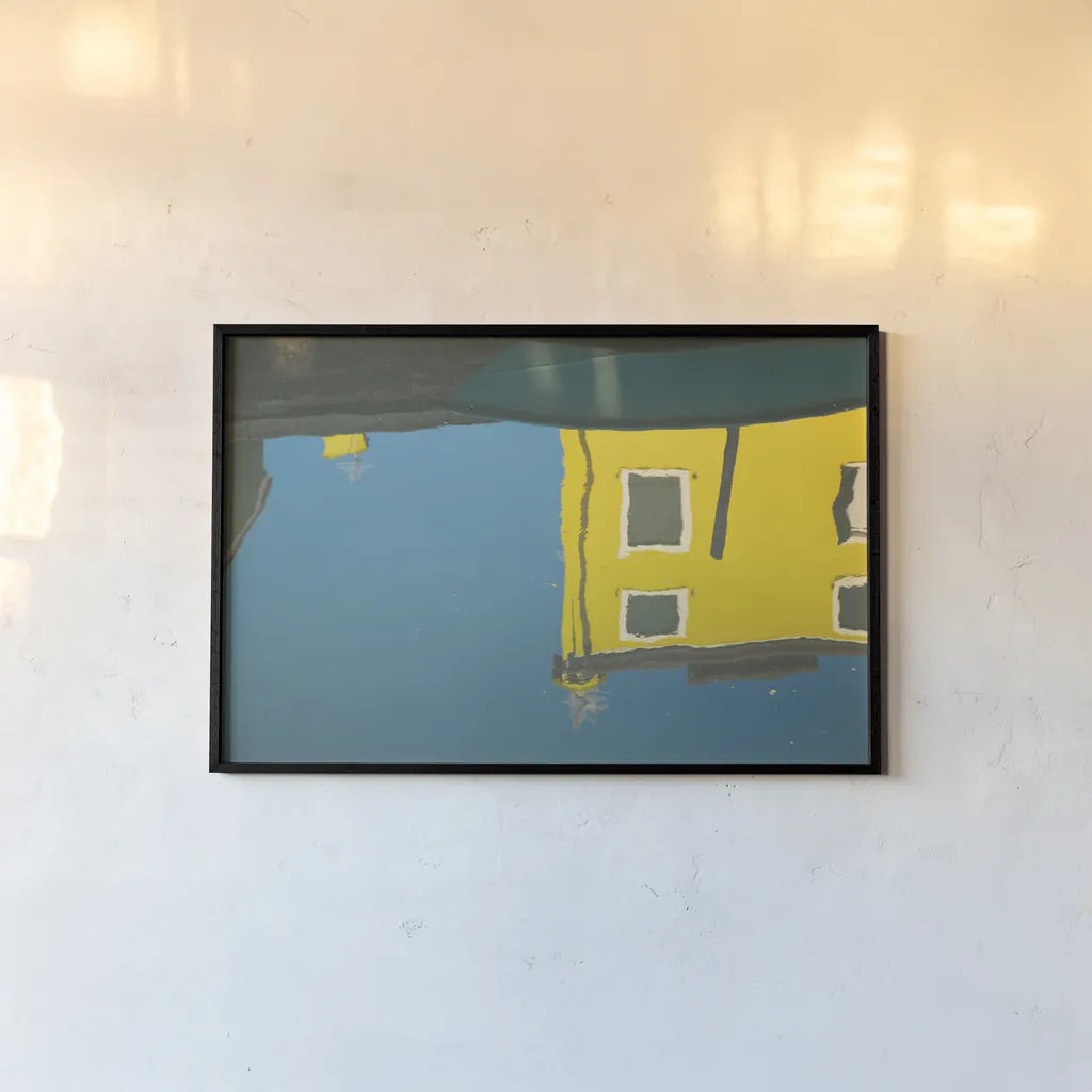Reflections of Burano VIII by Aledanda. shown as a paper print in a black flame. Available as a archival giclee rolled canvas, fine art paper, or poster print. SKU 41601i.
