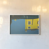 Reflections of Burano VIII by Aledanda. shown as a paper print in a white frame. Available as a archival giclee rolled canvas, fine art paper, or poster print. SKU 41601i.