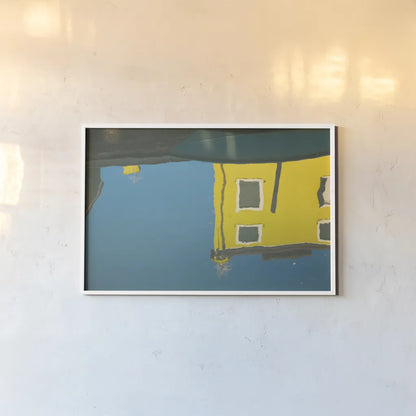Reflections of Burano VIII by Aledanda. shown as a paper print in a white frame. Available as a archival giclee rolled canvas, fine art paper, or poster print. SKU 41601i.