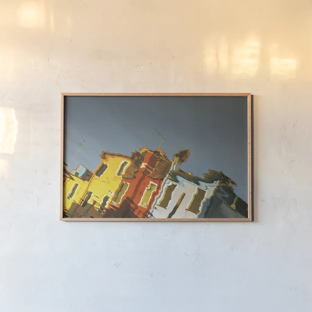 Reflections of Burano XI by Aledanda. shown as a paper print in a natural frame. Available as a archival giclee rolled canvas, fine art paper, or poster print. SKU 41604i.