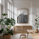 Skyscraper II BW by Aledanda. shown as a print in a natural wood frame in a dining room. Available as a archival giclee rolled canvas, fine art paper, or poster print. SKU 57207h.