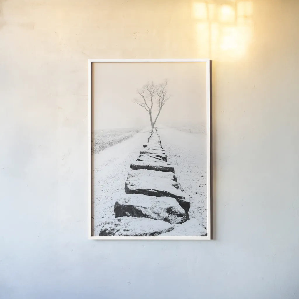 Snowy Stone Wall by Aledanda. shown as a paper print in a white frame. Available as a archival giclee rolled canvas, fine art paper, or poster print. SKU 64380h.