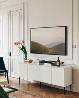 The Pass by Aledanda. shown as a framed stretched canvas in a living room above a console. Available as a archival giclee rolled canvas, fine art paper, or poster print. SKU 63232i.