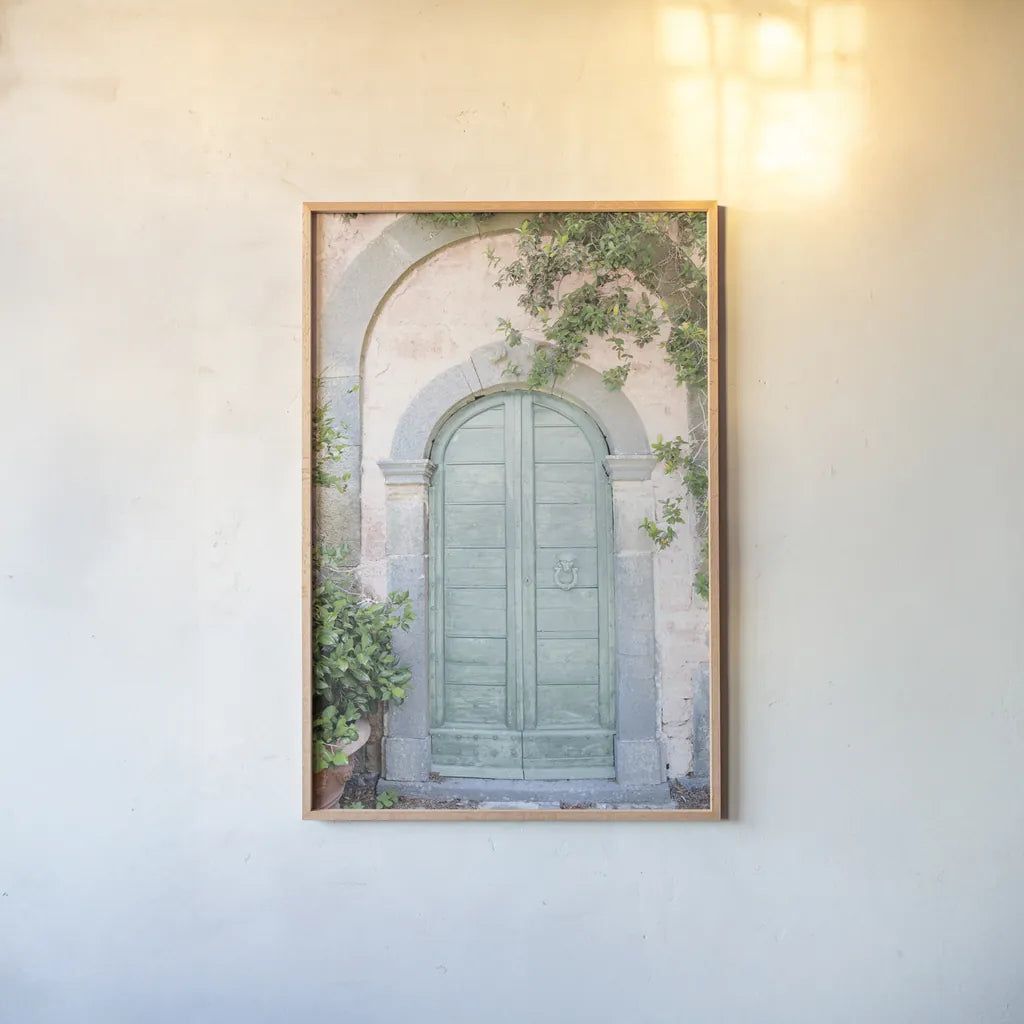 Venice Doorway Light by Aledanda. shown as a paper print in a natural frame. Available as a archival giclee rolled canvas, fine art paper, or poster print. SKU 67213h.