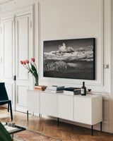 View of the Peaks by Aledanda. shown as a framed stretched canvas in a living room above a console. Available as a archival giclee rolled canvas, fine art paper, or poster print. SKU 67689i.