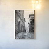 Village Square by Aledanda. shown as a paper print in a white frame. Available as a archival giclee rolled canvas, fine art paper, or poster print. SKU 67690h.