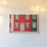 Windows of Burano VI by Aledanda. shown as a paper print in a white frame. Available as a archival giclee rolled canvas, fine art paper, or poster print. SKU 41612i.