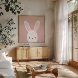 Cuddly Bunny Soft Pink by Ann Kelle. Shown in a natural wood frame in a cozy modern living room. Available as an archival giclee rolled canvas, fine art paper, or poster print. SKU 62025a.