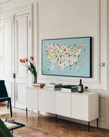 Fun USA Map by Ann Kelle. shown as a framed stretched canvas in a living room above a console. Available as a archival giclee rolled canvas, fine art paper, or poster print. SKU 62580i.