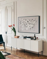 Fun USA Map BW by Ann Kelle. shown as a framed stretched canvas in a living room above a console. Available as a archival giclee rolled canvas, fine art paper, or poster print. SKU 66281i.