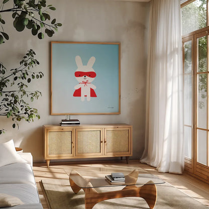 Rabbit Super Hero by Ann Kelle. Shown in a natural wood frame in a cozy modern living room. Available as an archival giclee rolled canvas, fine art paper, or poster print. SKU 55595a.