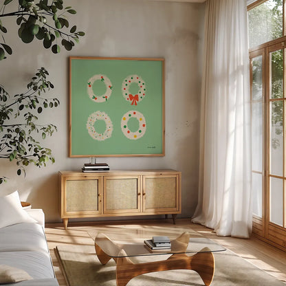 Wreaths by Ann Kelle. Shown in a natural wood frame in a cozy modern living room. Available as an archival giclee rolled canvas, fine art paper, or poster print. SKU 81238a.